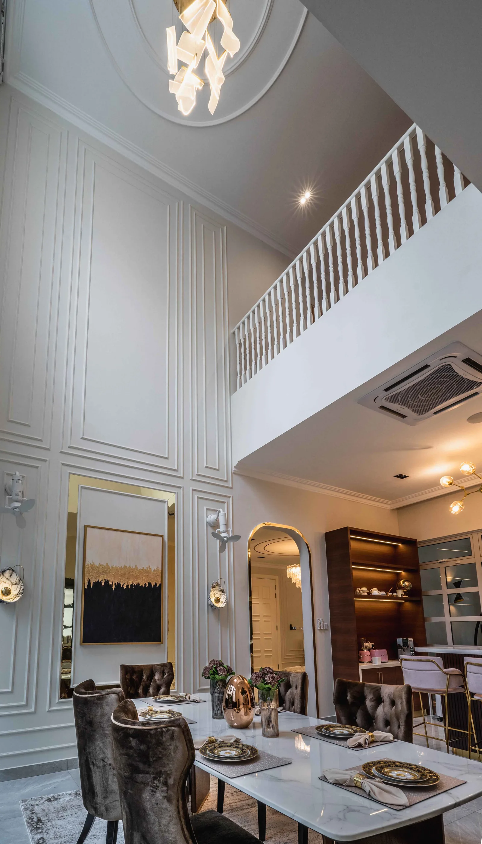 Double-height dining room with panelled walls, a sculptural chandelier and an upper-floor gallery, EcoSpring Villa, Johor Bahru, Malaysia, by Blaine Robert Design
