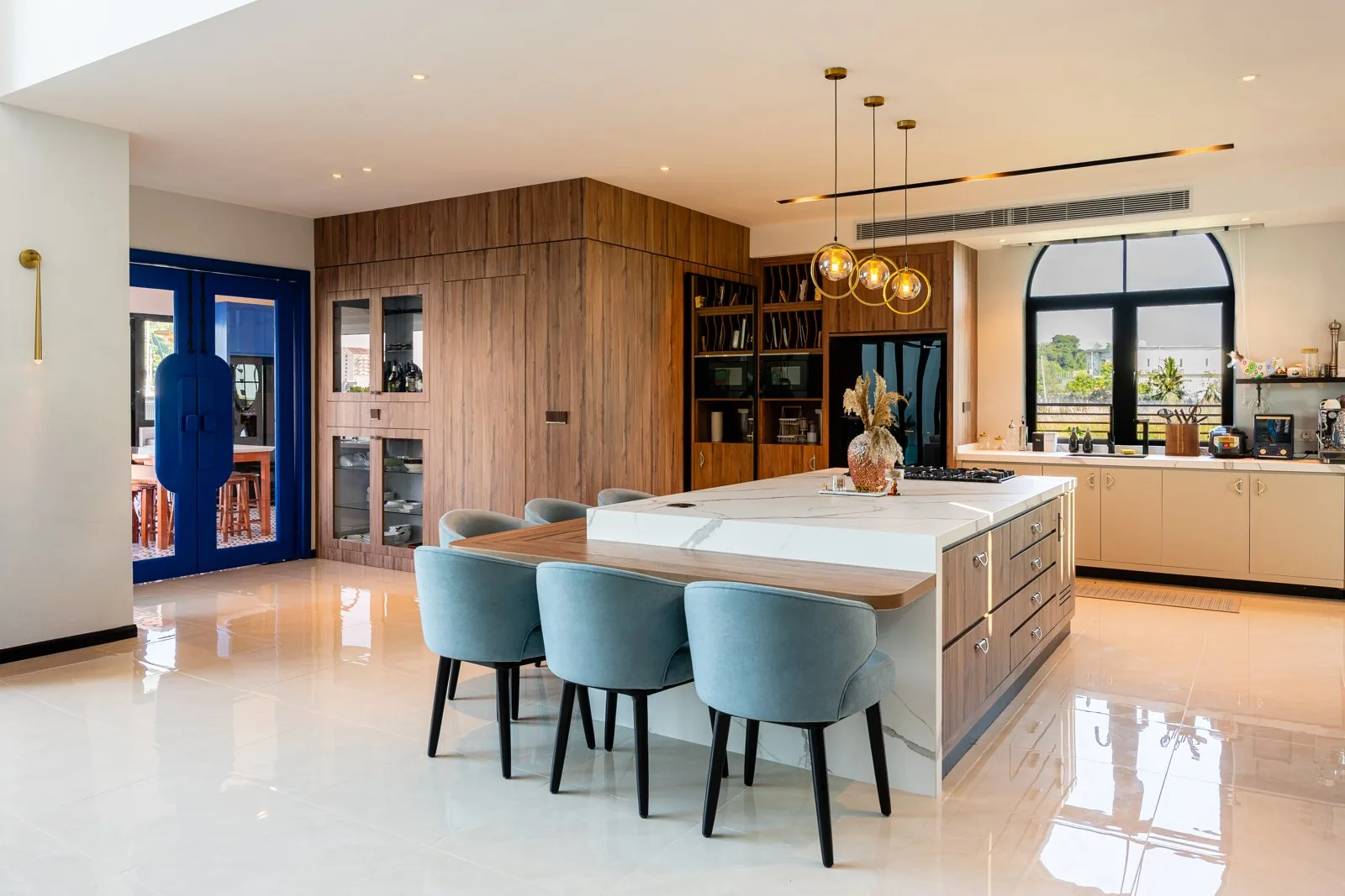 Kitchen island of deep drawers extending into a timber dining table, Quayside Villa, Port Dickson, Malaysia, by Blaine Robert Design