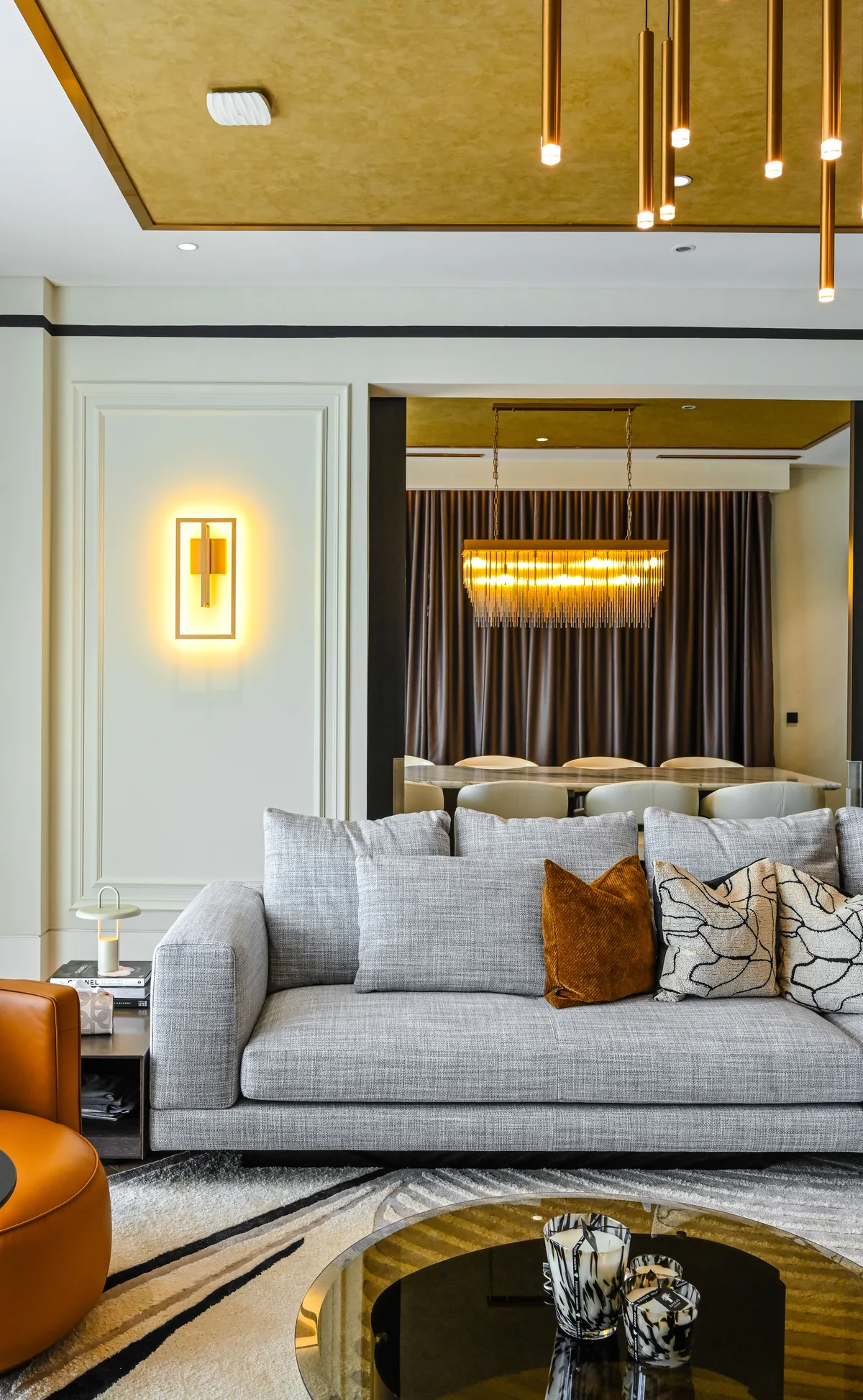 Living room with the dining room beyond under a gold-leaf ceiling and a crystal pendant, Aira Residence, Kuala Lumpur, Malaysia, by Blaine Robert Design