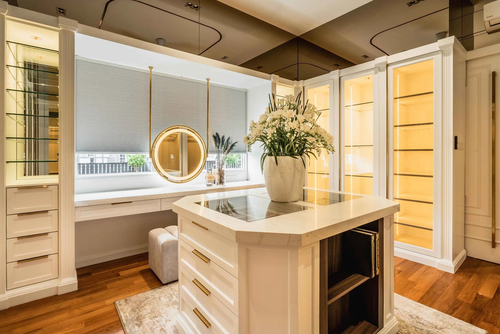 U-shaped walk-in closet with glass-fronted wardrobes, drawers and a round backlit mirror, Eco Spring, Johor Bahru, Malaysia, by Blaine Robert Design