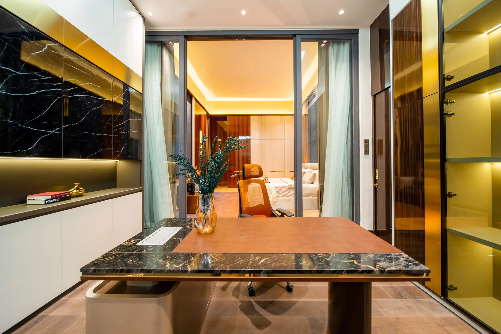 Marble-topped dressing island inside a walk-in wardrobe with lit glass shelves and a vanity, Bangsar, Kuala Lumpur, Malaysia, by Blaine Robert Design
