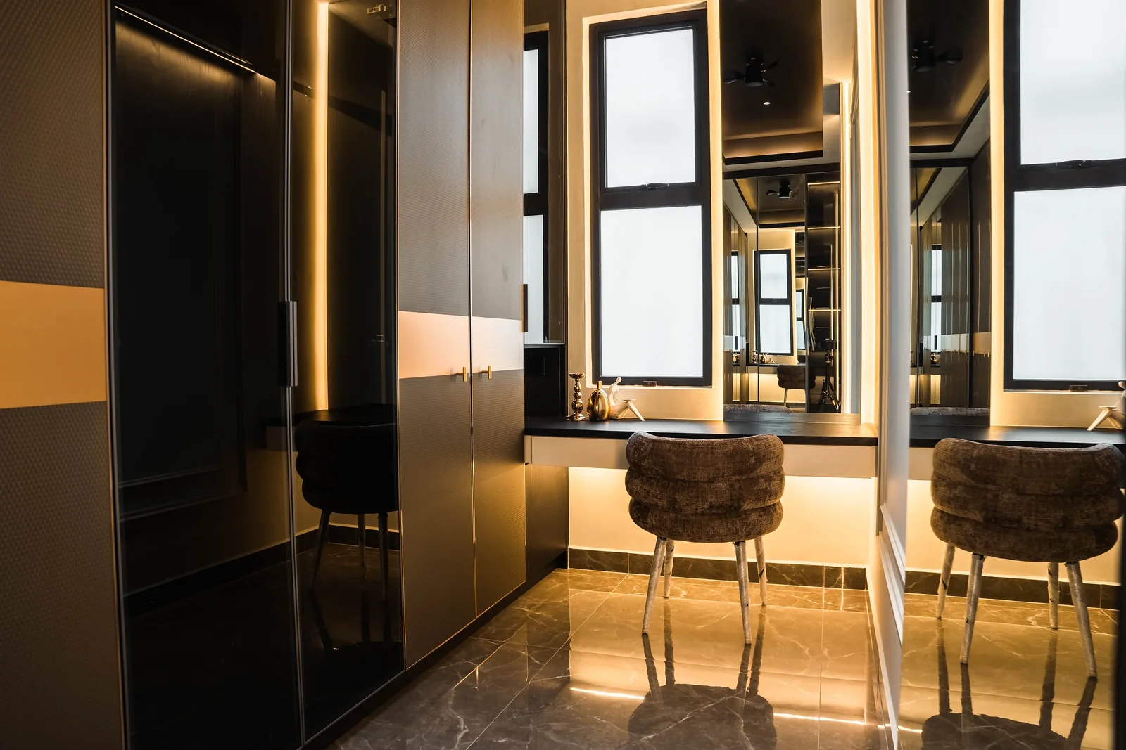 Dark lacquer and glass wardrobes with LED strip lighting and a vanity with two velvet stools, Setia Marina One, Cyberjaya, Malaysia, by Blaine Robert Design